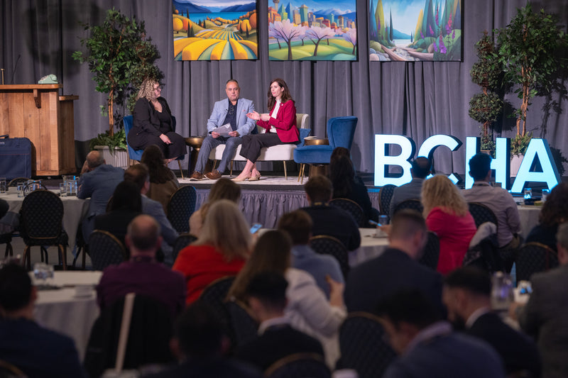 BCHA Summit panel with custom regional landscape artworks displayed as stage visuals.